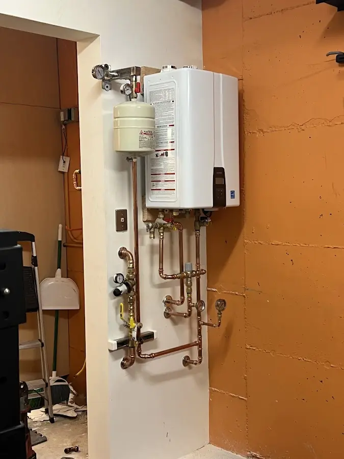 Plumbing technician inspecting water heater connections in Mount Dora